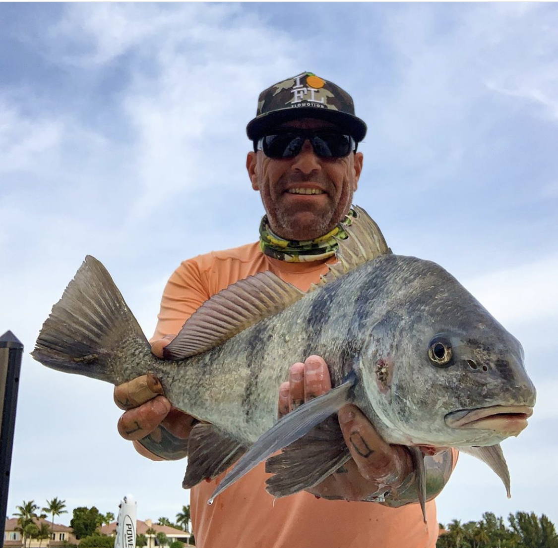 a picture of Capt. Nate holding a black drum he caught in Bradenton