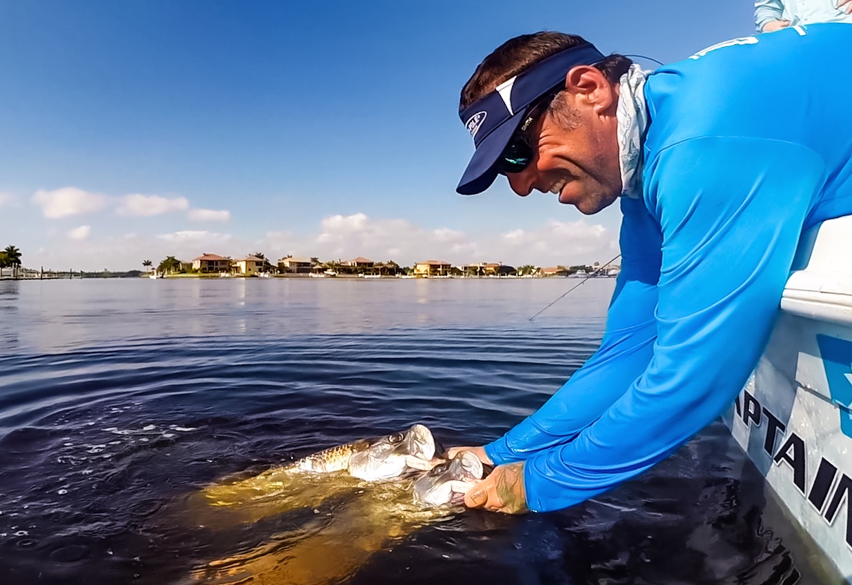 a picture of Captain Nate holding a fish he caught along Holmes Beach