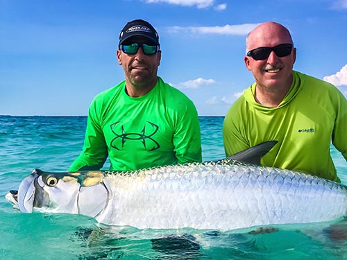 a picture of Capt. Nate and a fishing client holding a large Tarpon cought in the Sarasota, Florida coastal waters.